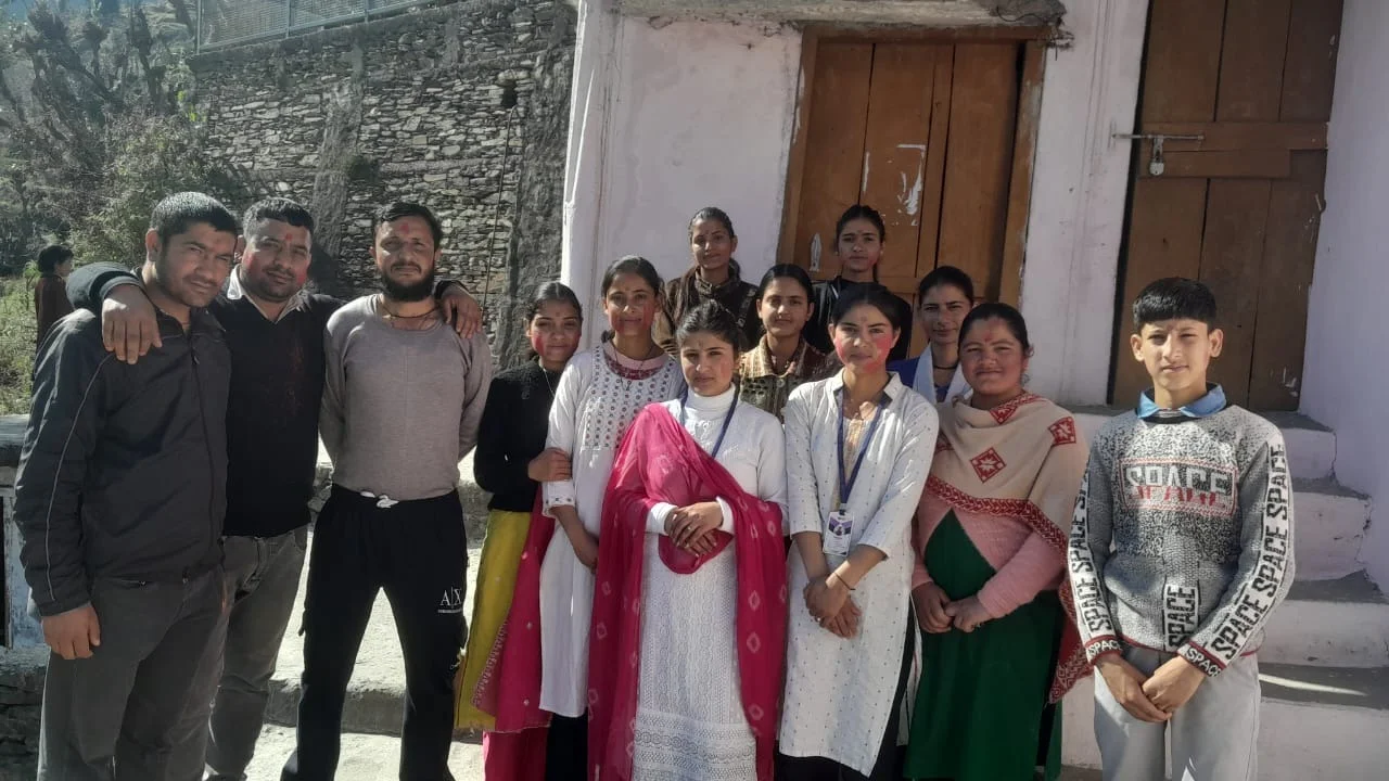 Office staff celebrating Holi with colors and happiness