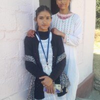 Two friends playing Holi with bright colors